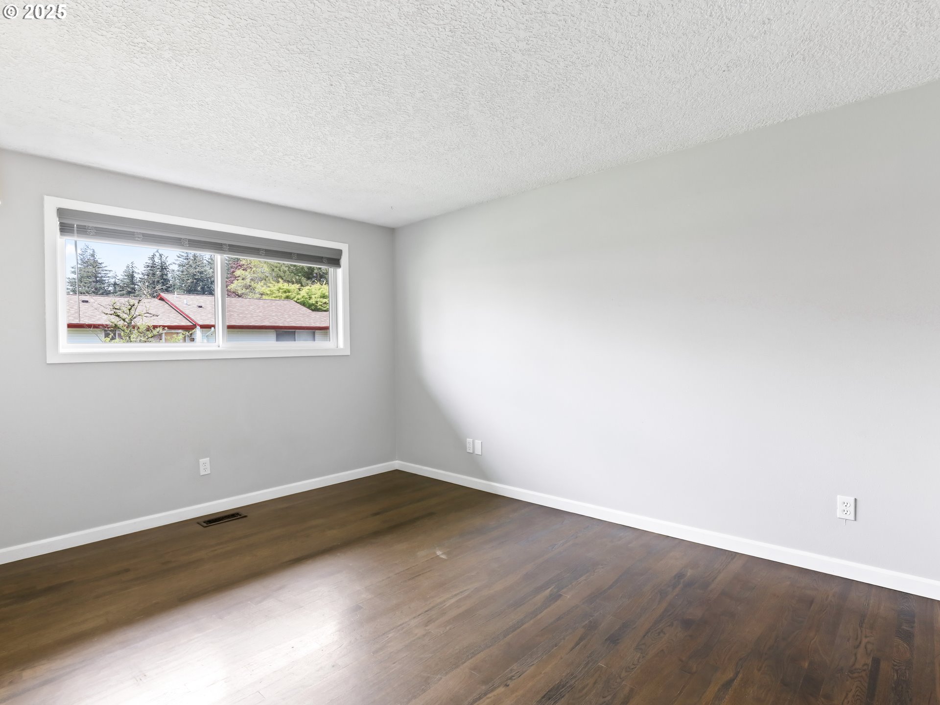 14967 Southeast Grant Court Portland, OR 97233 - Photo 18 of 46 an empty room with wooden floor and window