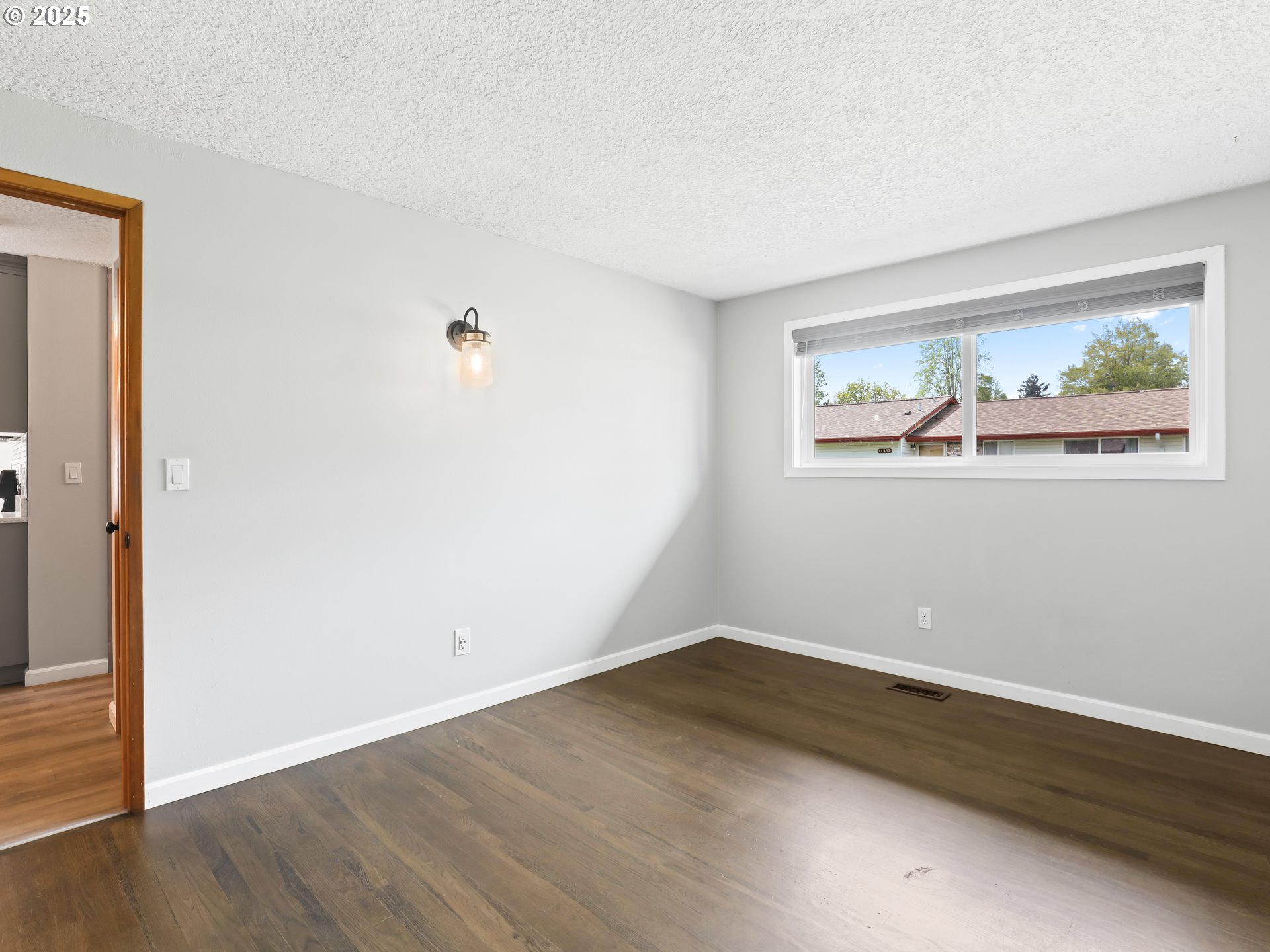 14967 Southeast Grant Court Portland, OR 97233 - Photo 19 of 46 an empty room with wooden floor and window