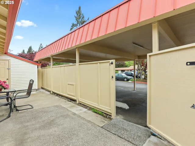 a view of a chairs and table in a back yard of the house
