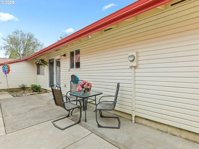 a view of a house with a yard and pathway