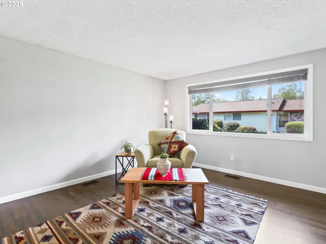 a living room with furniture rug and window