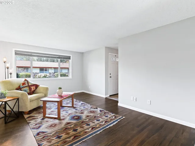 a living room with furniture and a book shelf