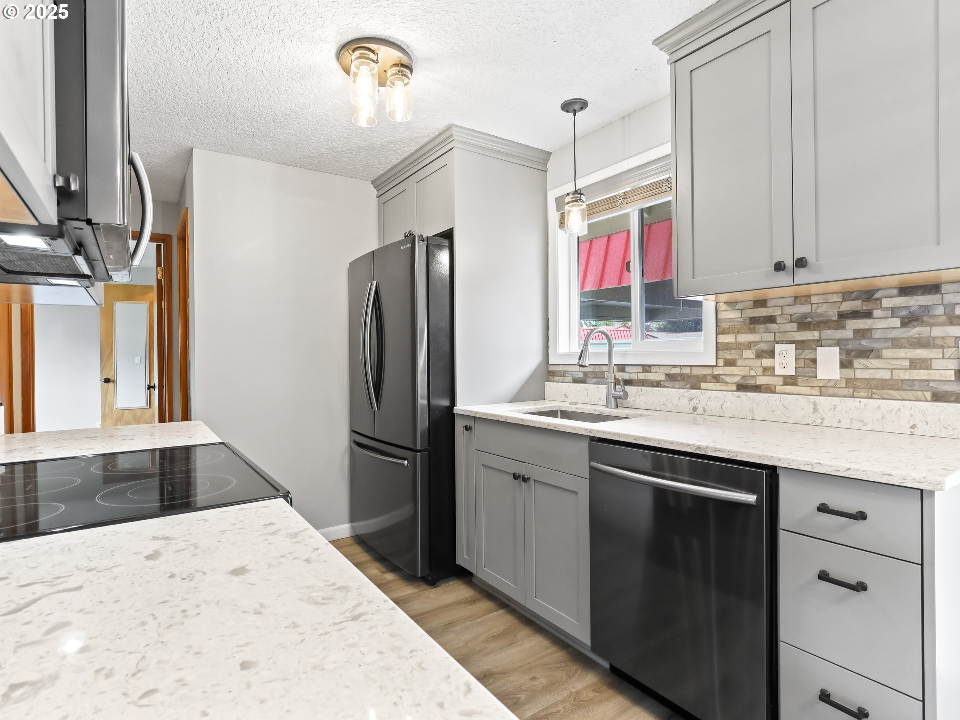 14967 Southeast Grant Court Portland, OR 97233 - Photo 10 of 46 a kitchen with a refrigerator sink and white cabinets