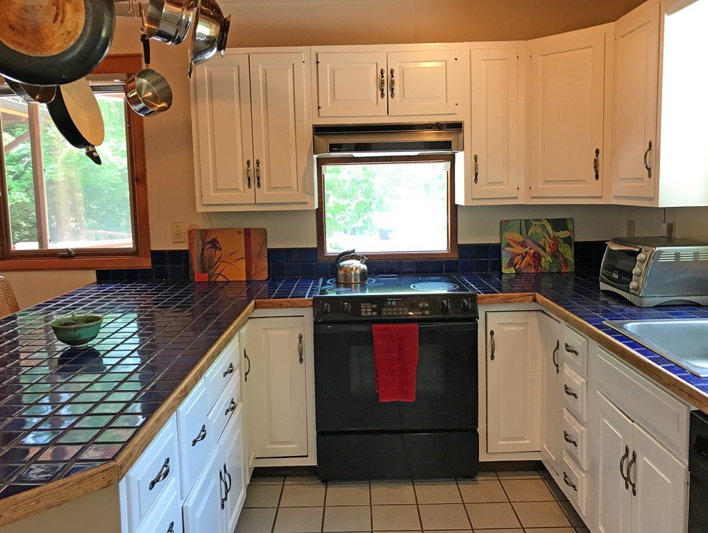 146 Bray Road Buckland, MA 01370 - Photo 17 of 30 a kitchen with stainless steel appliances granite countertop a stove a sink and a white cabinets