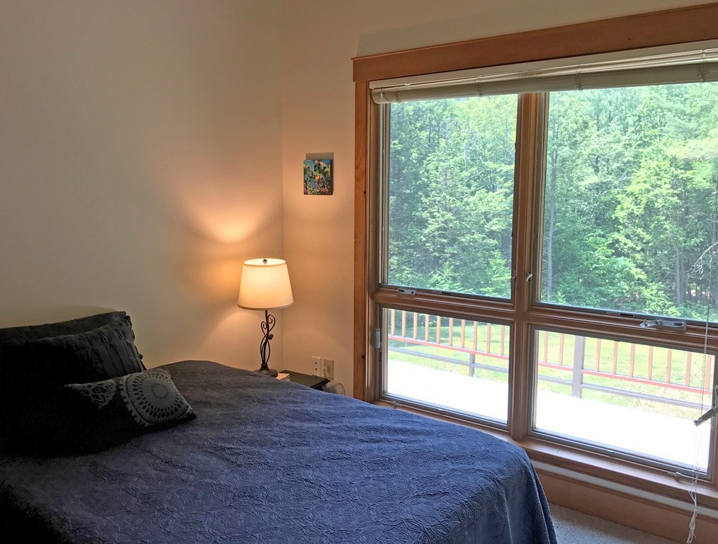 146 Bray Road Buckland, MA 01370 - Photo 23 of 30 a bedroom with a bed and a lamp next to a window