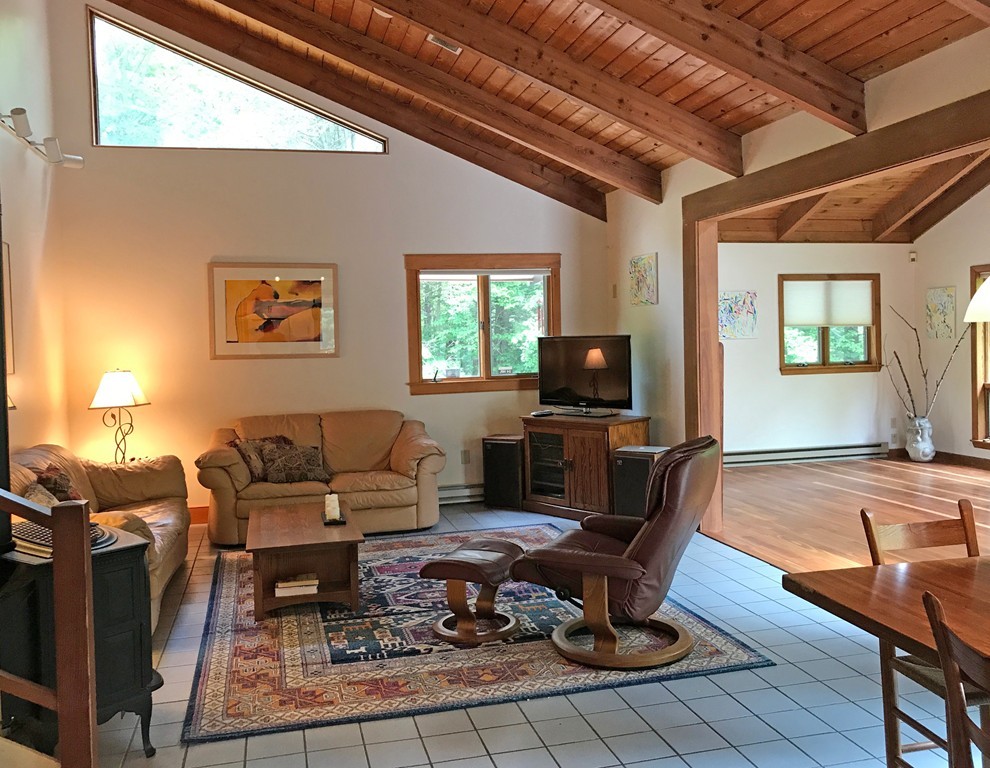 146 Bray Road Buckland, MA 01370 - Photo 7 of 30 a living room with furniture a flat screen tv and a large window