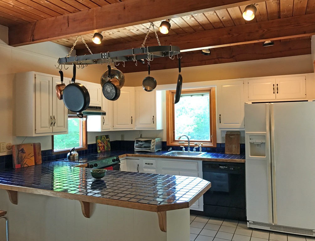 146 Bray Road Buckland, MA 01370 - Photo 9 of 30 a kitchen with stainless steel appliances granite countertop a sink window and refrigerator