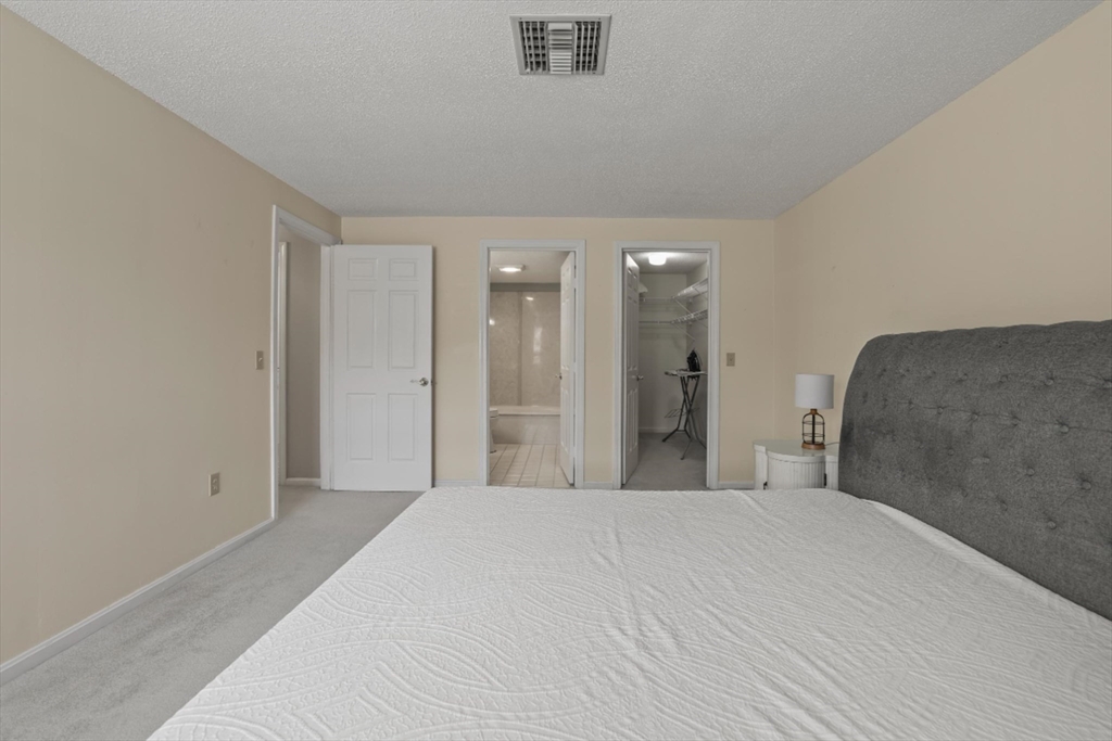 4234 North Main Street, Unit 208 Fall River, MA 02720 - Photo 11 of 27 a large bed in a white room