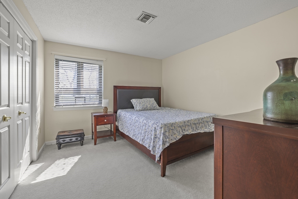 4234 North Main Street, Unit 208 Fall River, MA 02720 - Photo 13 of 27 a bedroom with a bed and a cabinets
