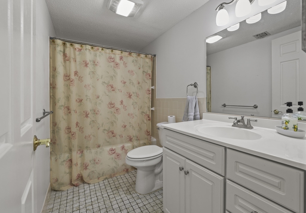 4234 North Main Street, Unit 208 Fall River, MA 02720 - Photo 15 of 27 a bathroom with a sink a toilet shower and a mirror