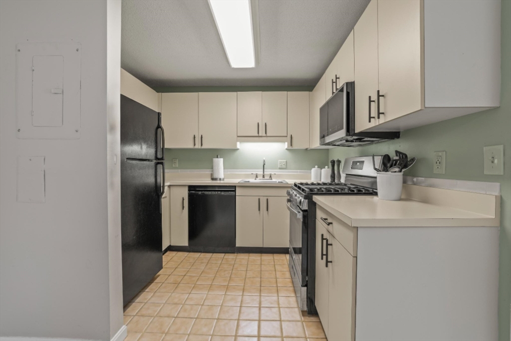 4234 North Main Street, Unit 208 Fall River, MA 02720 - Photo 4 of 27 a kitchen with stainless steel appliances granite countertop a sink stove and refrigerator