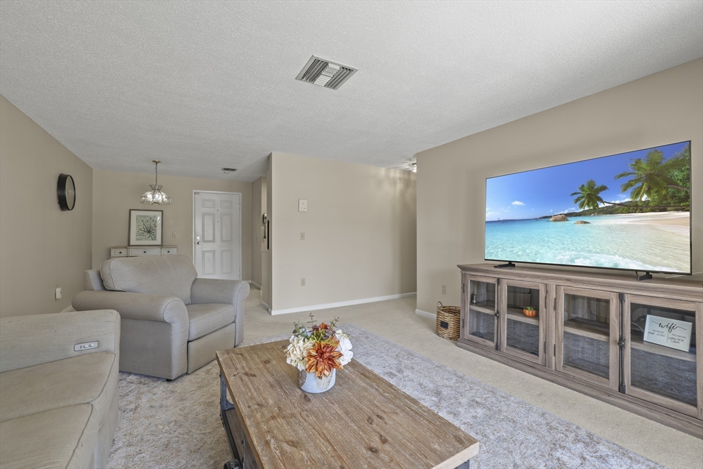 4234 North Main Street, Unit 208 Fall River, MA 02720 - Photo 6 of 27 a living room with furniture and a flat screen tv