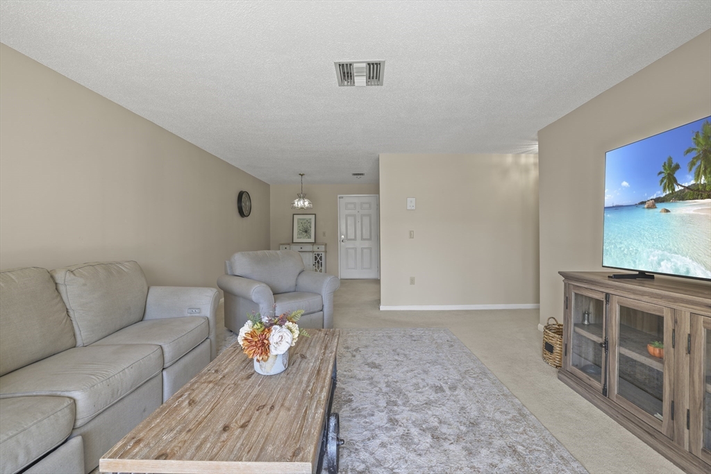 4234 North Main Street, Unit 208 Fall River, MA 02720 - Photo 7 of 27 a living room with furniture and a flat screen tv