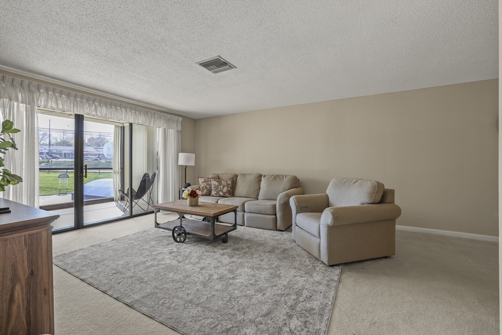 4234 North Main Street, Unit 208 Fall River, MA 02720 - Photo 8 of 27 a living room with furniture and large windows