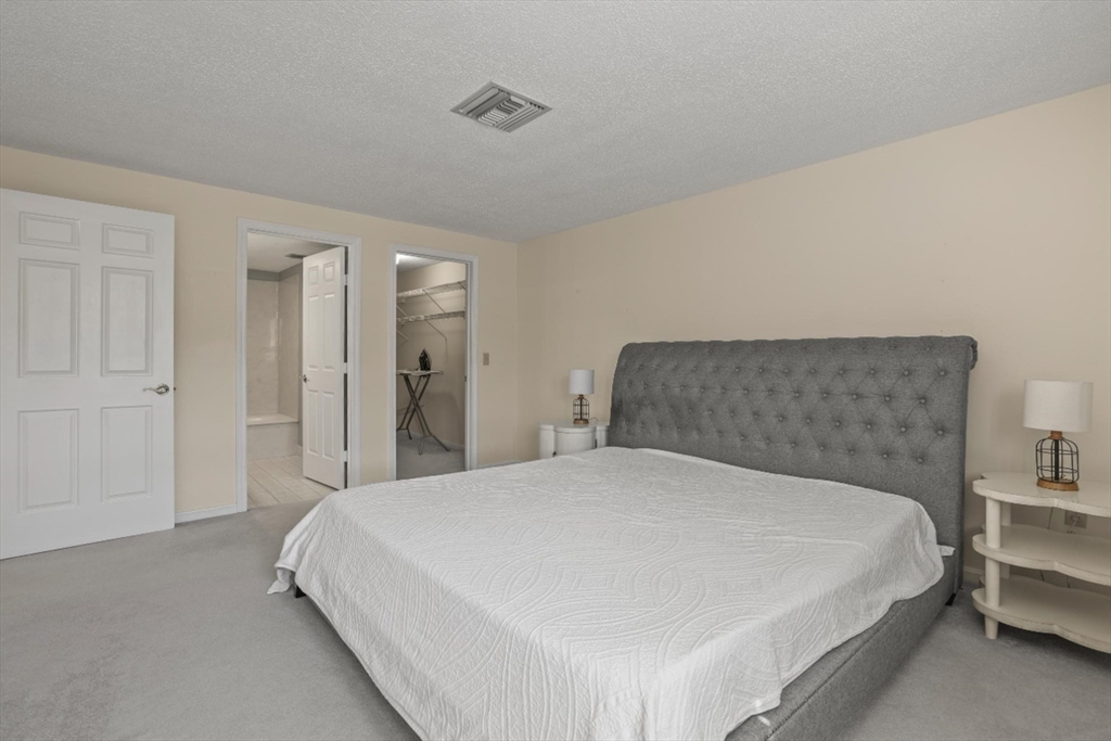 4234 North Main Street, Unit 208 Fall River, MA 02720 - Photo 10 of 27 a large bed sitting in a bedroom and closet