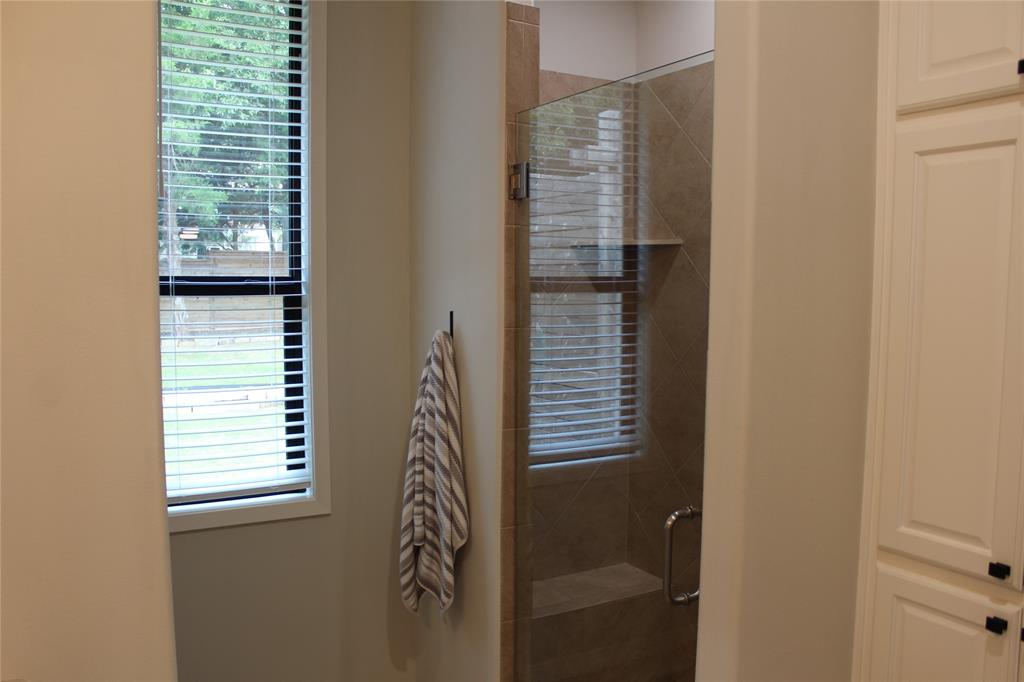 333 Renaissance Lane Heath, TX 75032 - Photo 24 of 35 Walk-in shower with clear glass enclosure and tile surround