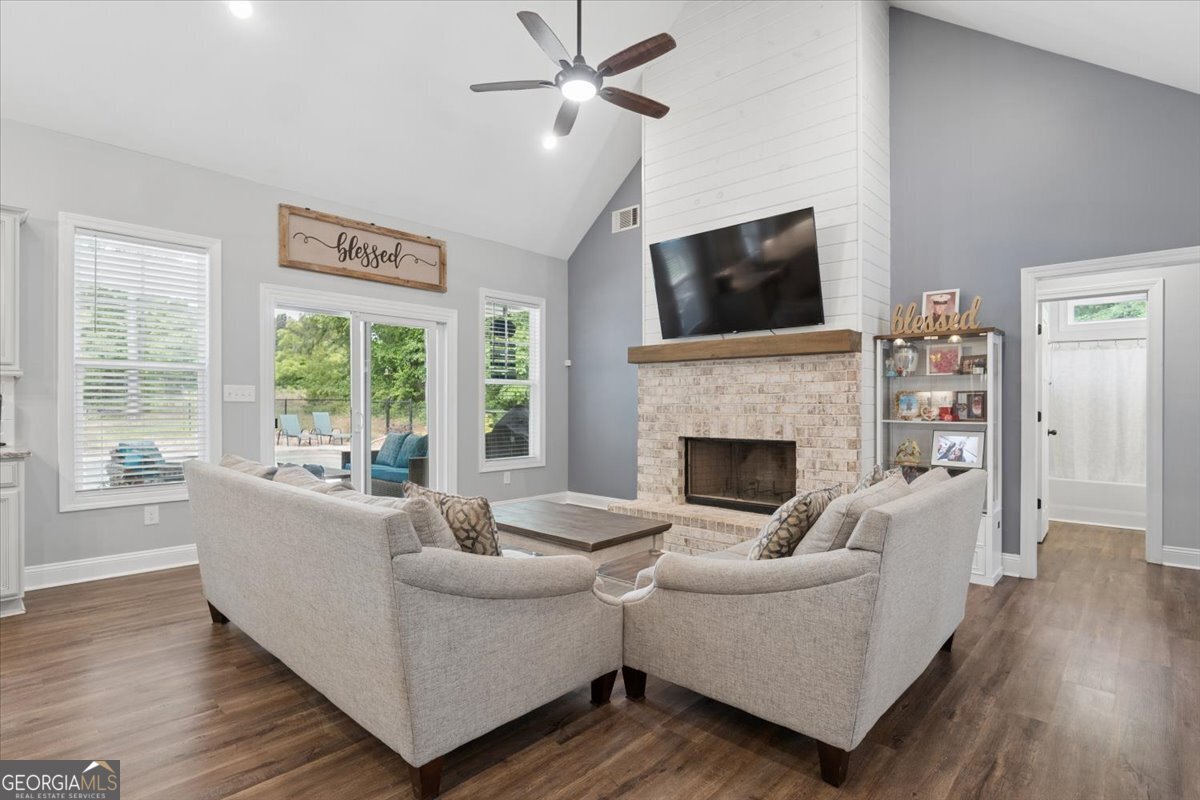 683 Teagle Road Forsyth, GA 31029 - Photo 12 of 50 a living room with furniture a flat screen tv and a fireplace