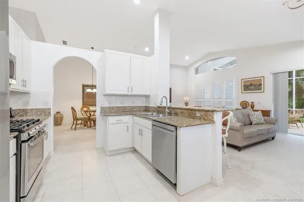 a kitchen with stainless steel appliances granite countertop a stove and a microwave