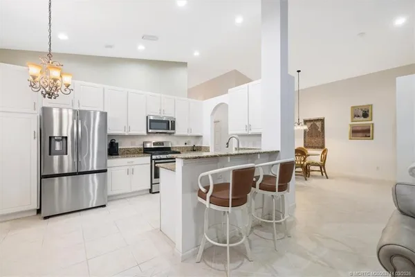 a dining room with furniture and chandelier