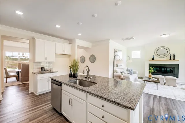 a kitchen with sink cabinets and living room