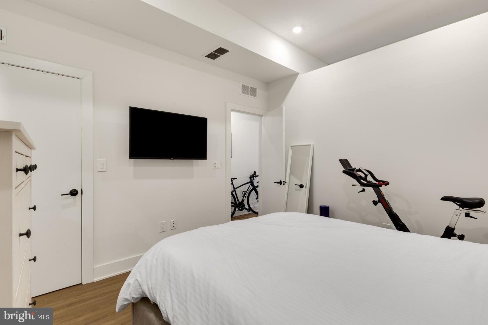 630 Federal Street, Unit 304 Philadelphia, PA 19147 - Photo 15 of 26 a bedroom with a bed and a flat screen tv