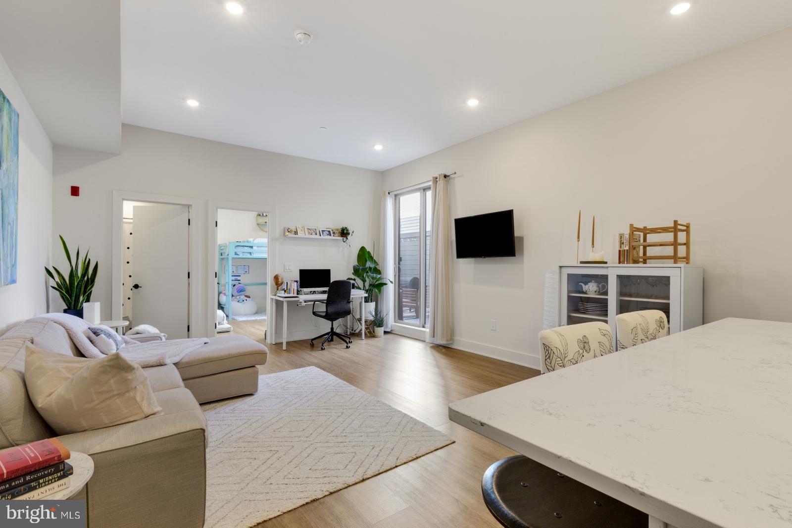 630 Federal Street, Unit 304 Philadelphia, PA 19147 - Photo 2 of 26 a living room with furniture and a flat screen tv