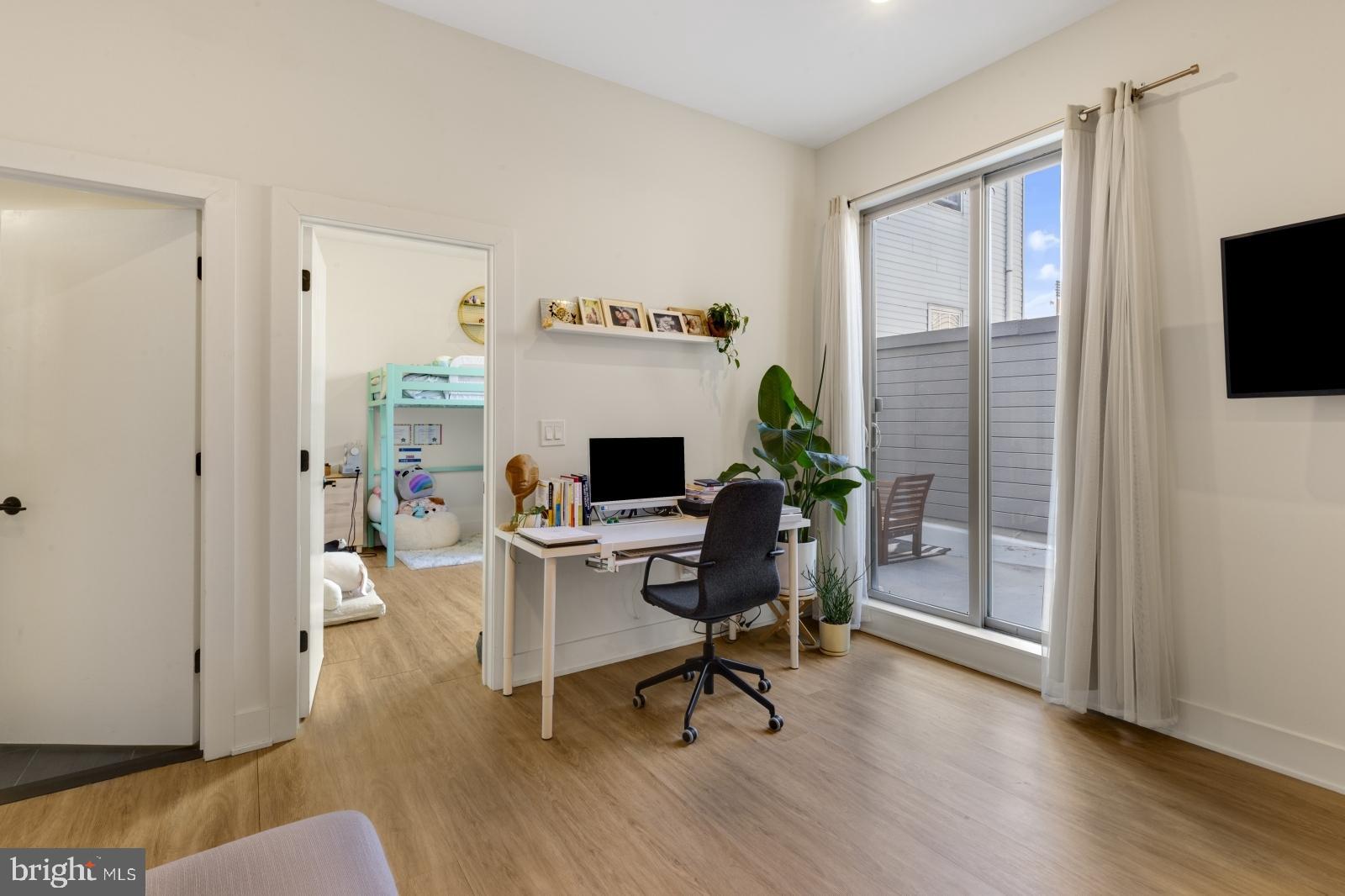 630 Federal Street, Unit 304 Philadelphia, PA 19147 - Photo 10 of 26 a workspace with furniture window and wooden floor