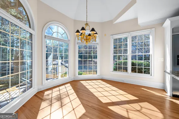 a view of a kitchen with white cabinets