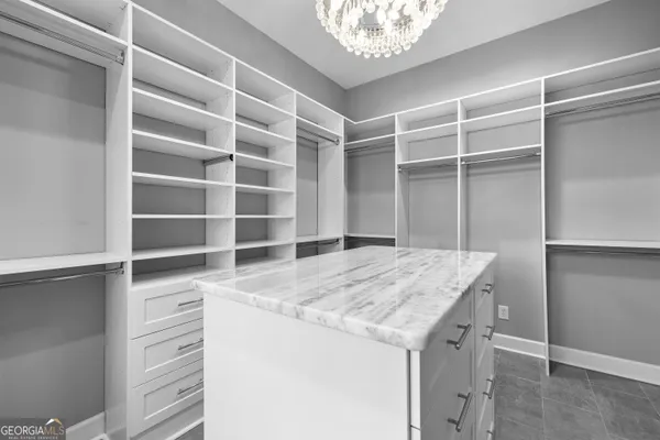 a bathroom with a granite countertop bathtub shower and toilet
