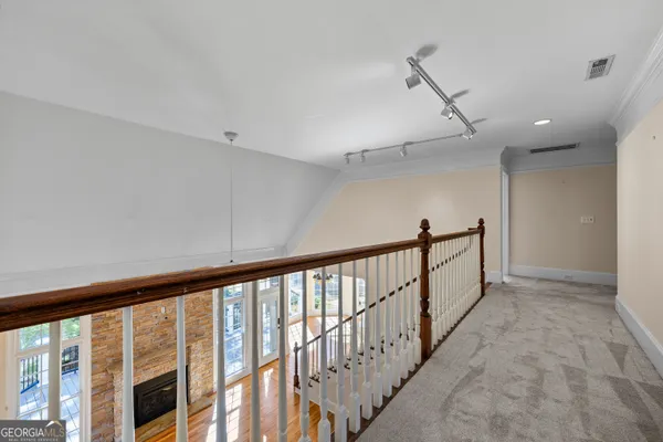 a view of an empty room with window and fireplace