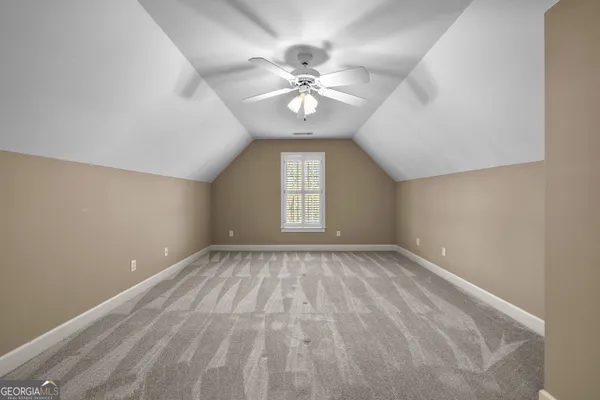 a bathroom with a granite countertop sink a mirror and a shower