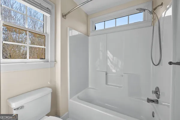 an aerial view of a house with a yard and large trees