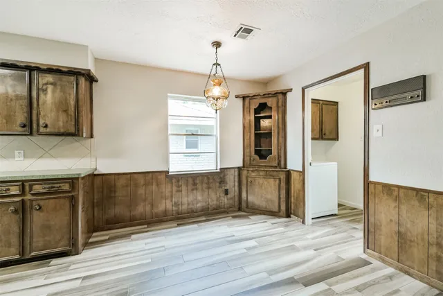 a bathroom with a granite countertop double vanity and a large mirror