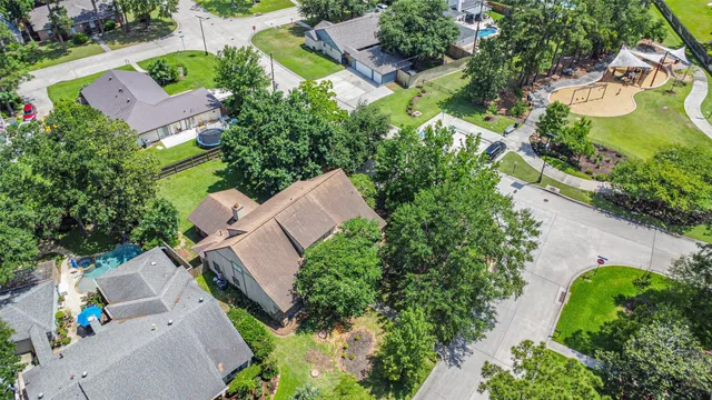 an aerial view of a house with garden space and street view