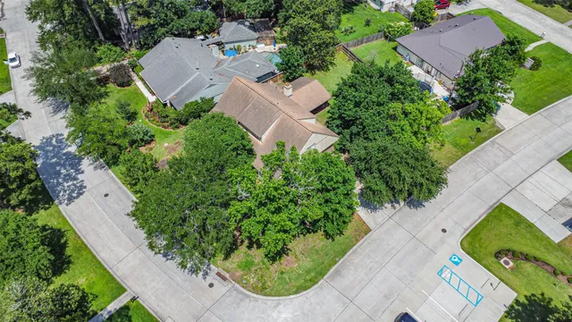 an aerial view of a house with garden space and street view