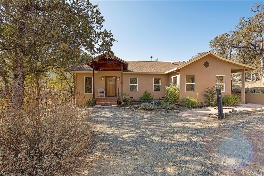 13188 Spruce Grove Road Lower Lake, CA 95457 - Photo 1 of 1 a front view of a house with a garden