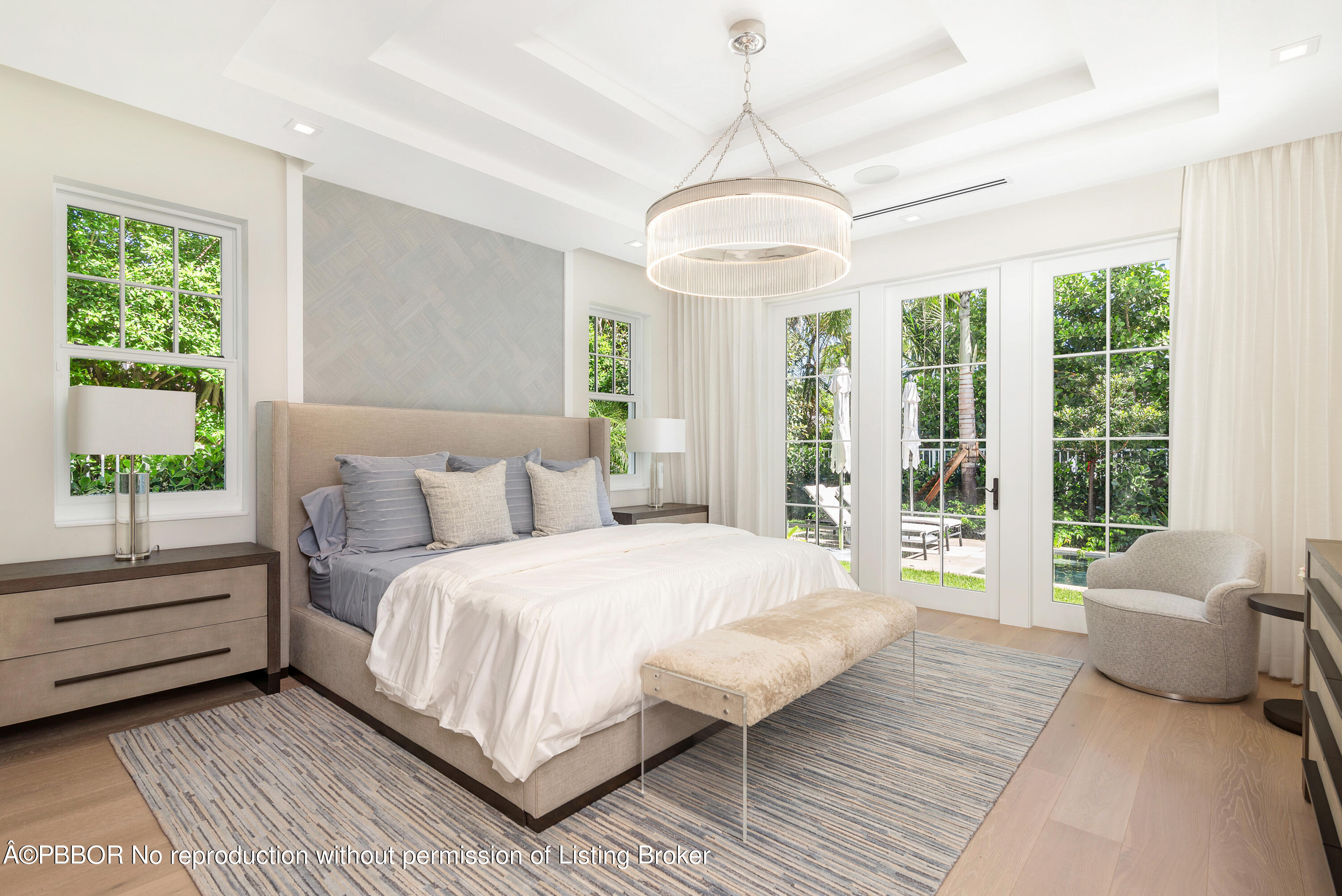 223 Monterey Road Palm Beach, FL 33480 - Photo 23 of 44 a spacious bedroom with a large bed and a chandelier