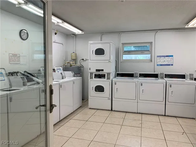 a utility room with cabinets washer and dryer