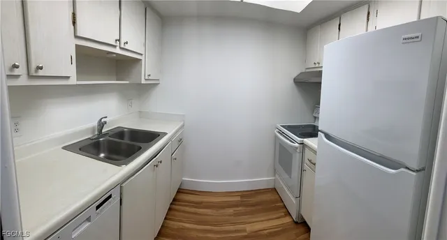 a utility room with sink dryer and washer