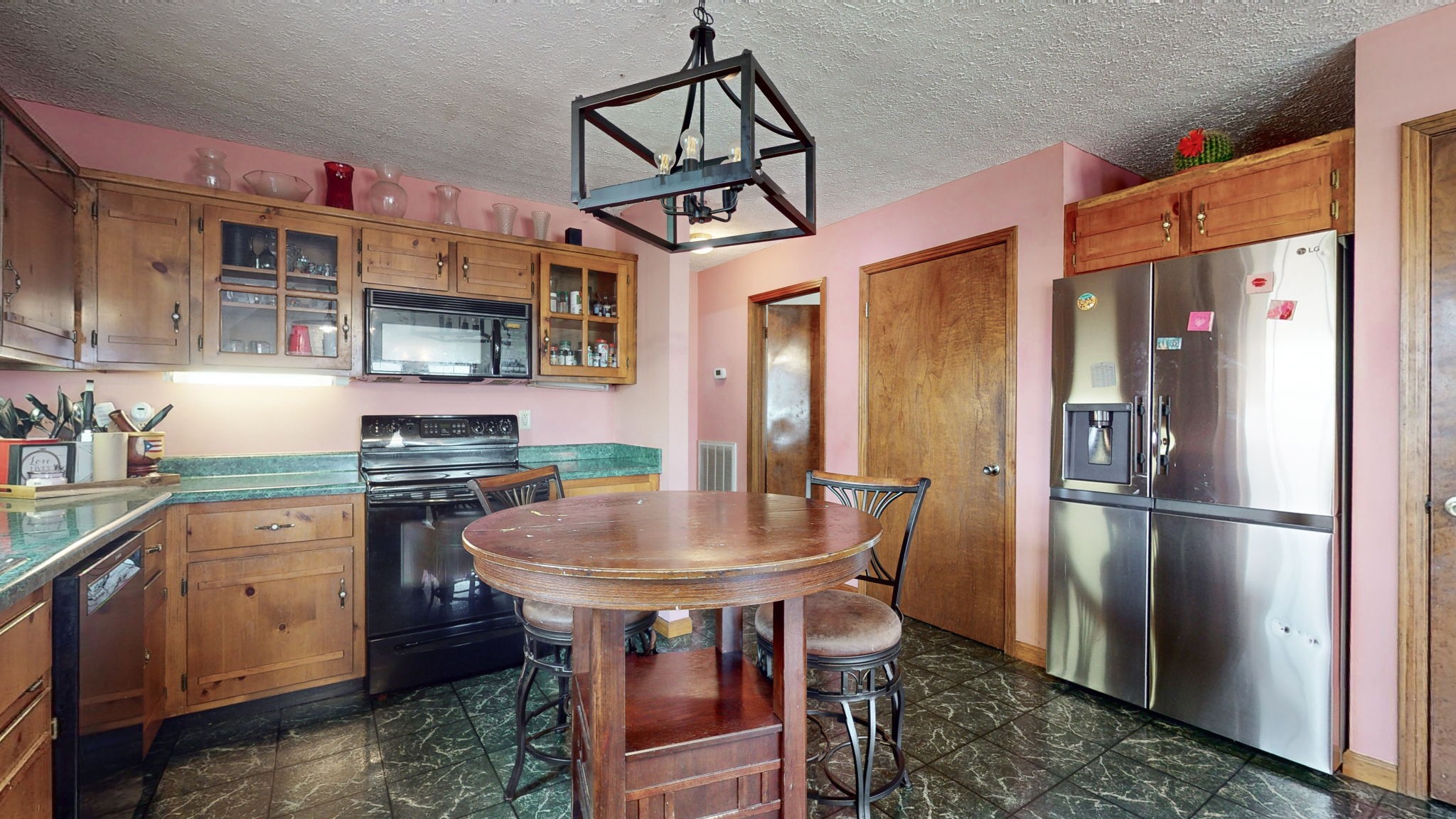 2459 Toler Road Woodlawn, TN 37191 - Photo 11 of 48 a kitchen with stainless steel appliances a dining table chairs refrigerator and sink
