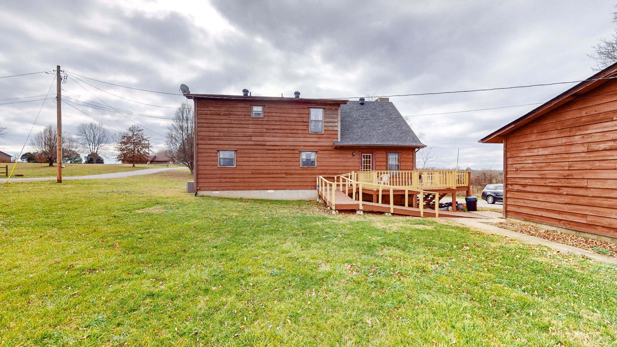 2459 Toler Road Woodlawn, TN 37191 - Photo 27 of 48 a view of a house with a yard and sitting area