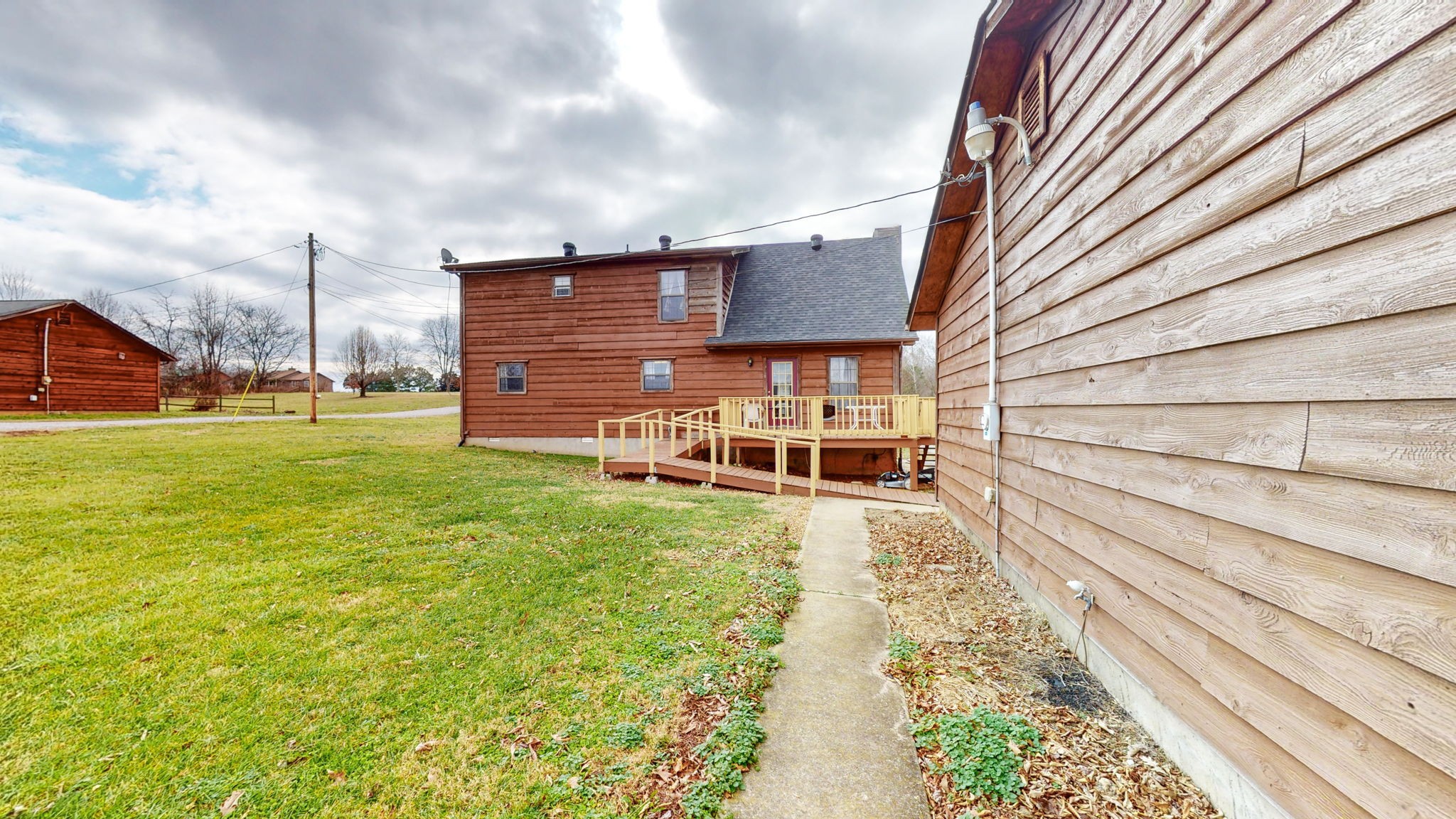 2459 Toler Road Woodlawn, TN 37191 - Photo 28 of 48 a backyard of a house with table and chairs