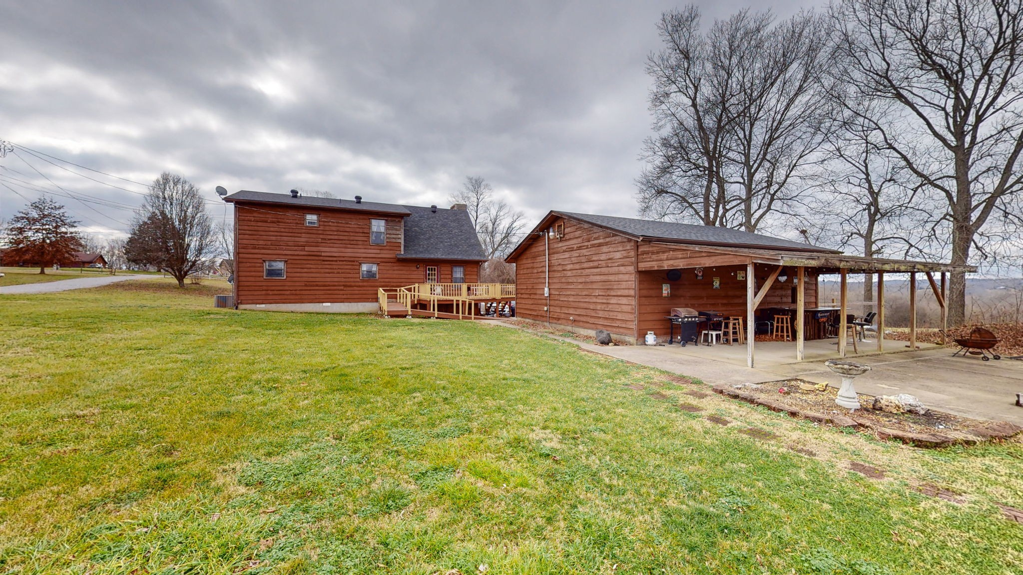 2459 Toler Road Woodlawn, TN 37191 - Photo 30 of 48 a view of a house with a yard and sitting area