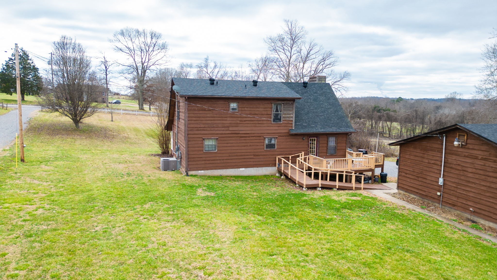 2459 Toler Road Woodlawn, TN 37191 - Photo 42 of 48 a front view of a house with garden