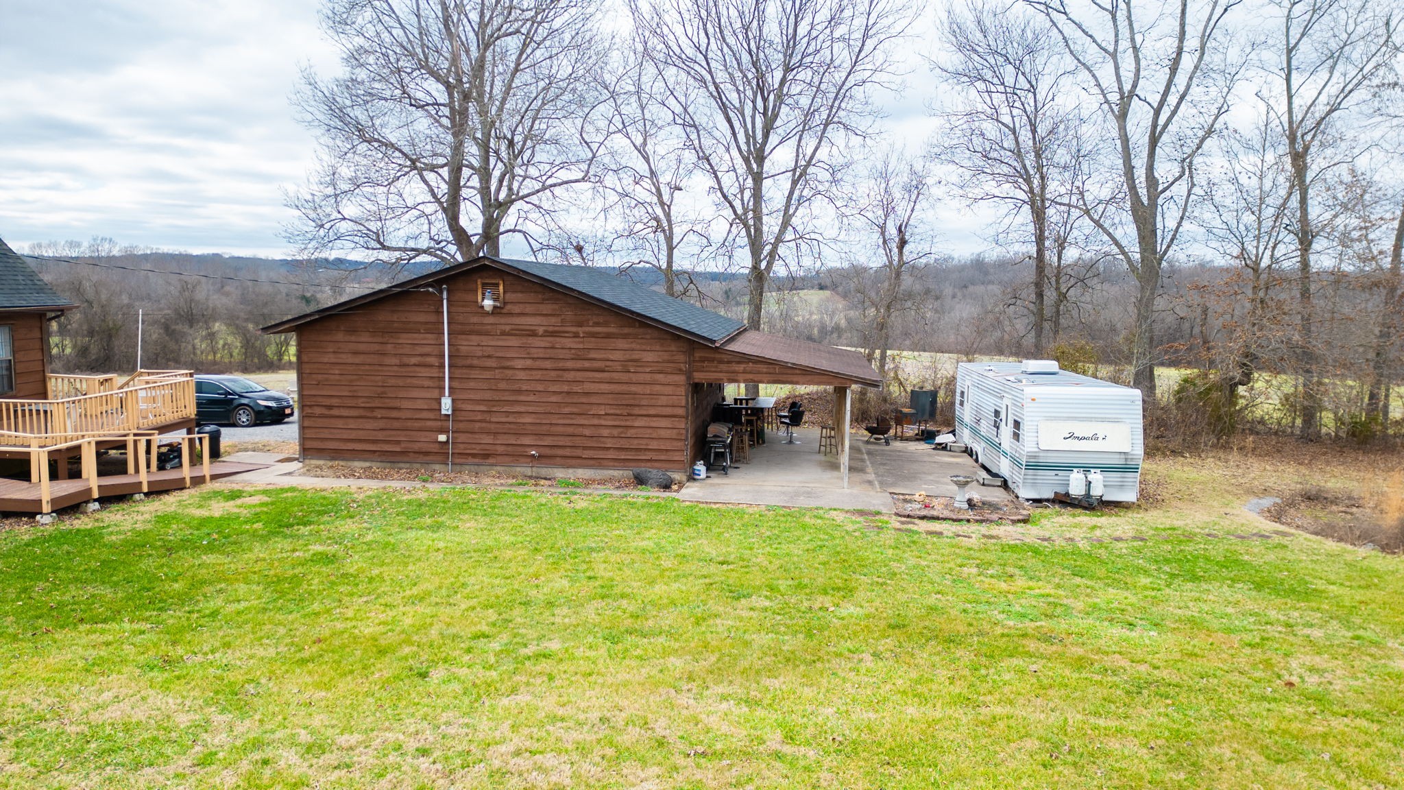 2459 Toler Road Woodlawn, TN 37191 - Photo 44 of 48 a backyard of a house with table and chairs