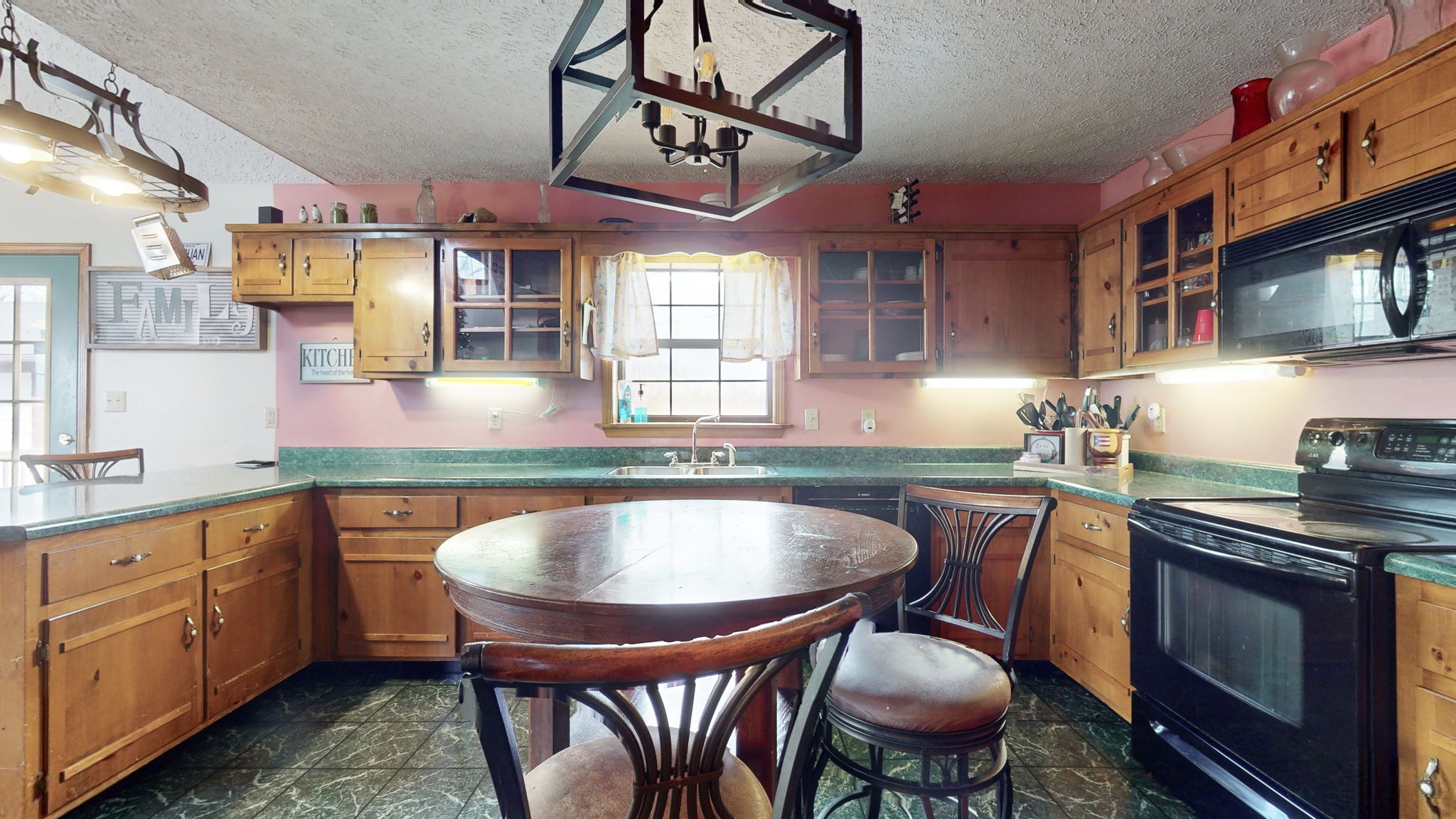 2459 Toler Road Woodlawn, TN 37191 - Photo 10 of 48 a kitchen with stainless steel appliances granite countertop a sink a stove a table and chairs