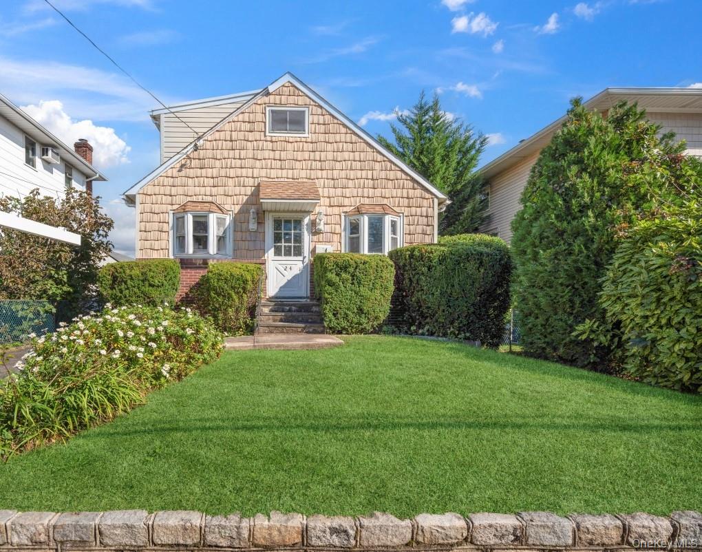 24 Hickory Road Port Washington, NY 11050 - Photo 1 of 1 a front view of a house with a garden