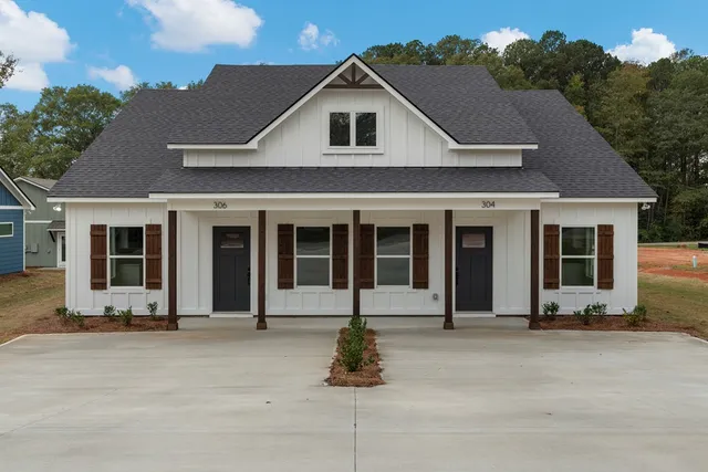 a front view of a house with a garden
