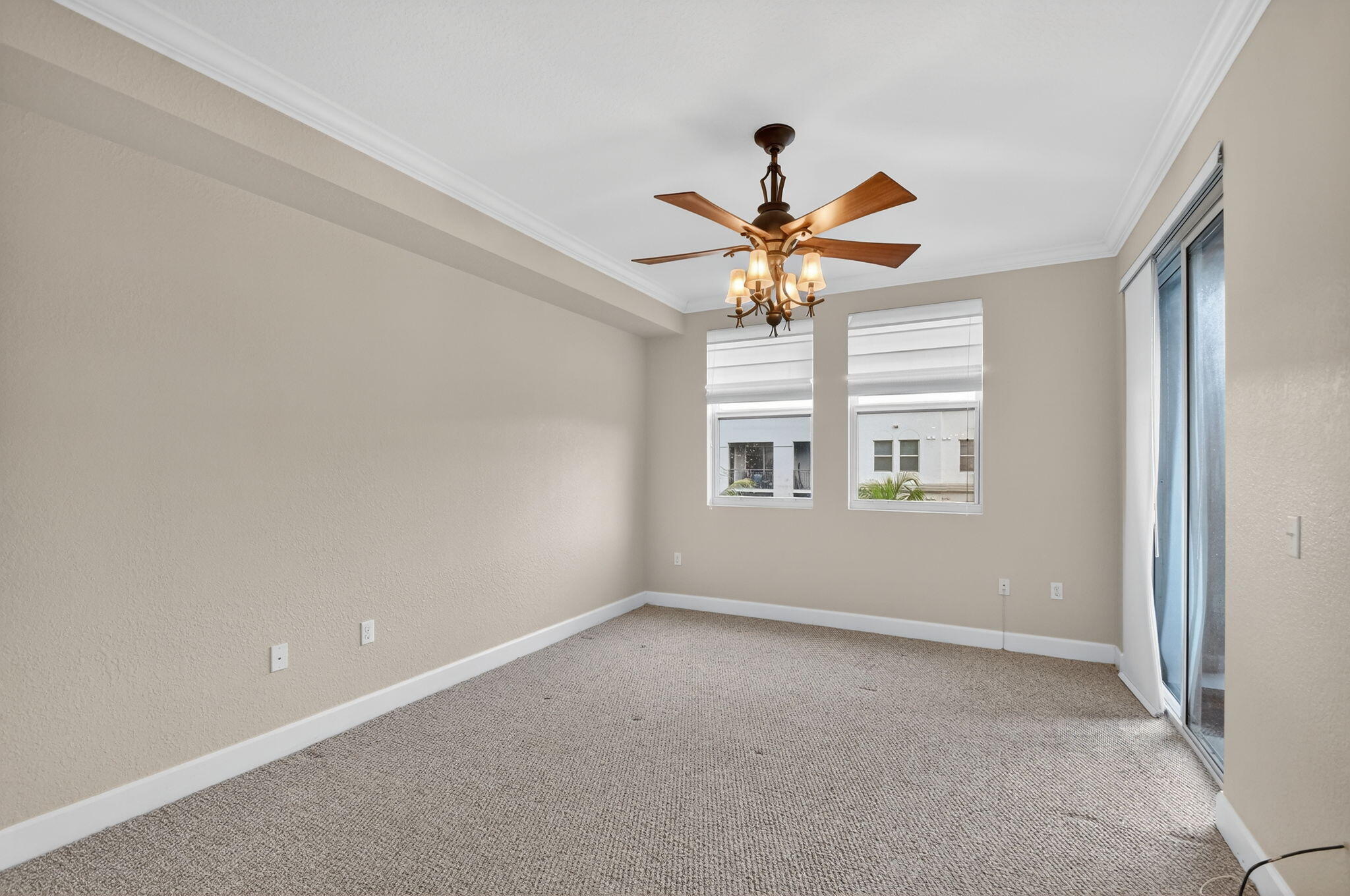 1660 Renaissance Commons Boulevard, Unit 2627 Boynton Beach, FL 33426 - Photo 10 of 32 en empty room with windows and ceiling fan