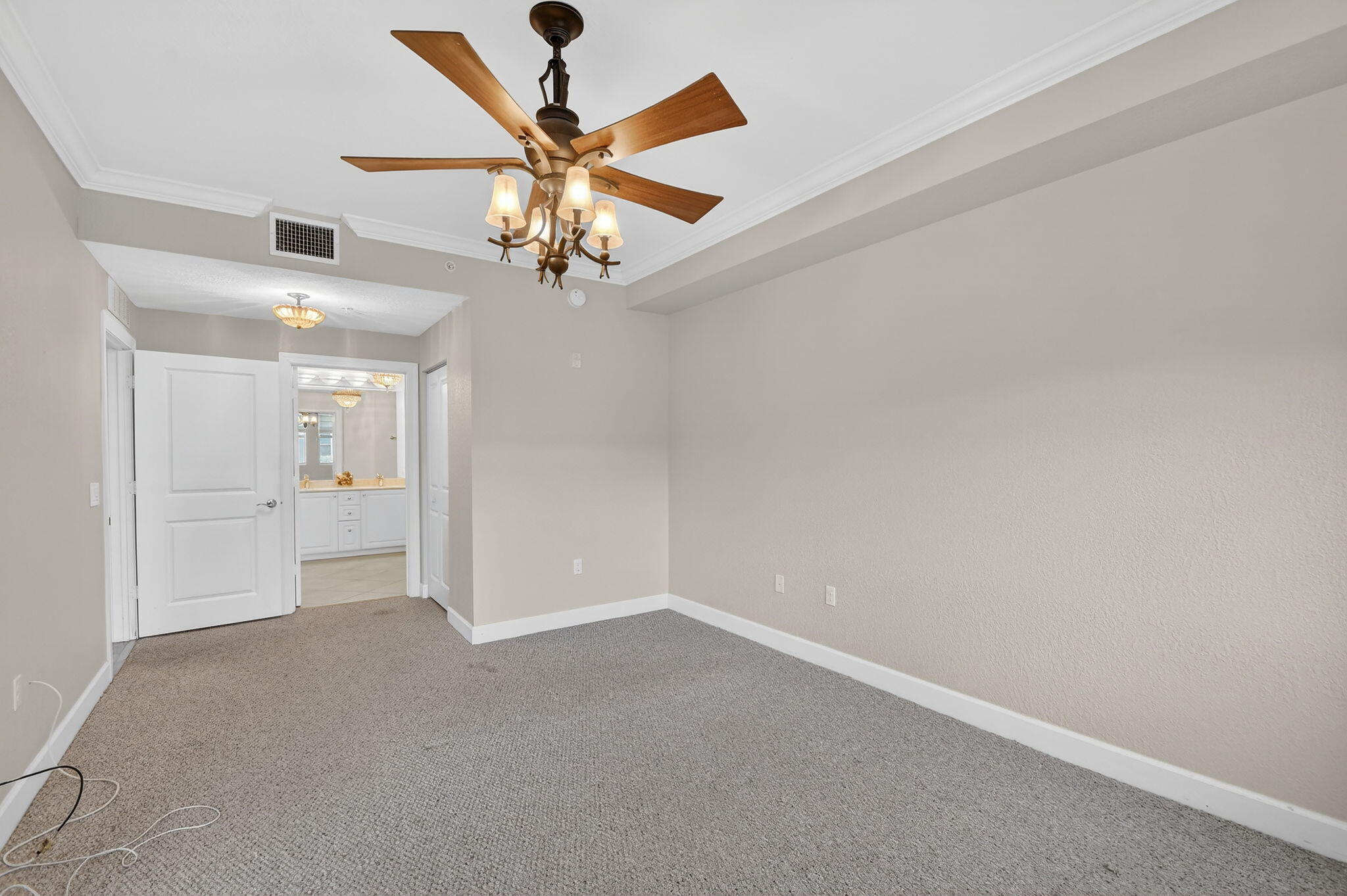 1660 Renaissance Commons Boulevard, Unit 2627 Boynton Beach, FL 33426 - Photo 11 of 32 an empty room and chandelier fan